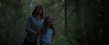 Movie still from “Pete's Dragon” (2016), directed by David Lowery – A woman standing next to a young girl in a forest; Medium shot, Low angle
