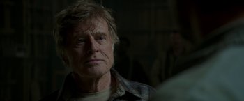 Movie still from “Pete's Dragon” (2016), directed by David Lowery – An older man is looking into the camera; Close Up shot, Over the shoulder angle