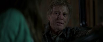 Movie still from “Pete's Dragon” (2016), directed by David Lowery – An older man with a beard and a plaid shirt; Close Up shot, Over the shoulder angle