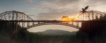 Movie still from “Pete's Dragon” (2016), directed by David Lowery – An image of a train going over a bridge in the middle of the day; Extreme Wide shot, Low angle