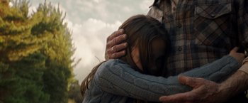 Movie still from “Pete's Dragon” (2016), directed by David Lowery – Two people hugging each other in a wooded area; Close Up shot, Over the shoulder angle