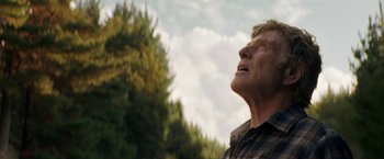 Movie still from “Pete's Dragon” (2016), directed by David Lowery – An older man is looking up into the sky; Close Up shot, Low angle