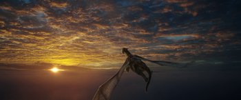 Movie still from “Pete's Dragon” (2016), directed by David Lowery – A cat is flying a kite in the sky at sunset; Extreme Wide shot, Low angle