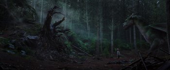Movie still from “Pete's Dragon” (2016), directed by David Lowery – A person standing next to a tree in the woods; Extreme Wide shot, Low angle