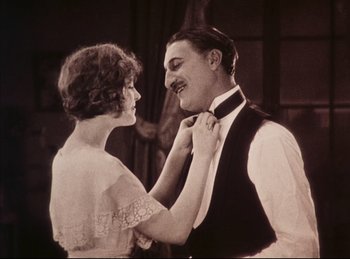 Movie still from “Peter Pan” (1924), directed by Herbert Brenon – An old photo of a man and a woman; Medium shot, Low angle