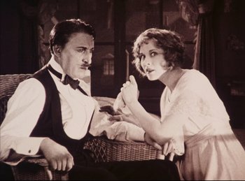 Movie still from “Peter Pan” (1924), directed by Herbert Brenon – A man and a woman sitting next to each other; Medium shot, Low angle
