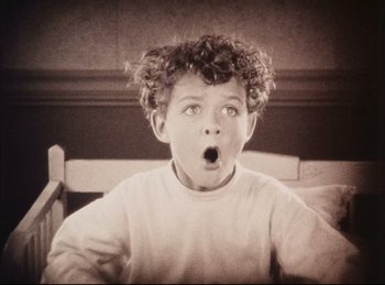 Movie still from “Peter Pan” (1924), directed by Herbert Brenon – A young boy with a surprised look on his face; Close Up shot, High angle