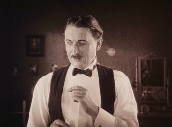 Movie still from “Peter Pan” (1924), directed by Herbert Brenon – A man with a mustache wearing a bow tie; Close Up shot, Low angle