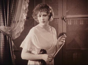 Movie still from “Peter Pan” (1924), directed by Herbert Brenon – An old photo of a woman holding a cane; Medium shot, High angle