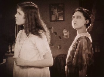 Movie still from “Peter Pan” (1924), directed by Herbert Brenon – Two young women standing next to each other in a room; Medium shot, Low angle