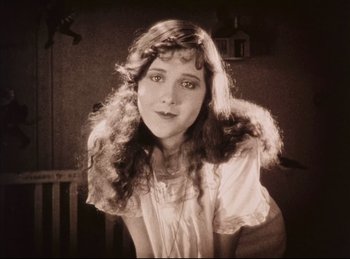 Movie still from “Peter Pan” (1924), directed by Herbert Brenon – An old photo of a woman with long hair; Close Up shot, High angle