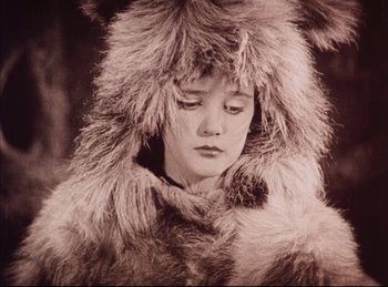 Movie still from “Peter Pan” (1924), directed by Herbert Brenon – A young woman wearing a fur coat and a fur hat; Close Up shot, High angle