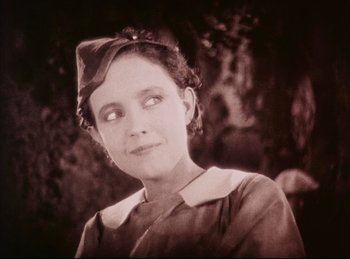 Movie still from “Peter Pan” (1924), directed by Herbert Brenon – An old photo of a woman wearing a hat; Close Up shot, High angle