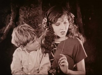 Movie still from “Peter Pan” (1924), directed by Herbert Brenon – A young boy and a young girl sitting next to each other; Medium shot, High angle
