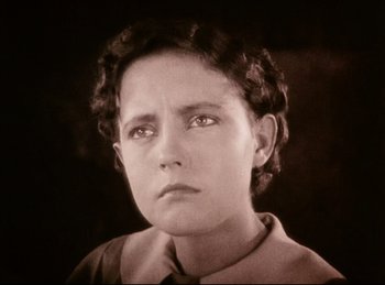 Movie still from “Peter Pan” (1924), directed by Herbert Brenon – An old photo of a woman looking at the camera; Close Up shot, High angle