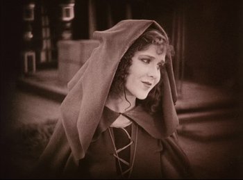 Movie still from “Peter Pan” (1924), directed by Herbert Brenon – A woman in a medieval dress with a head covering; Close Up shot, High angle