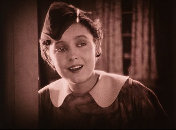 Movie still from “Peter Pan” (1924), directed by Herbert Brenon – An old photo of a woman in a hat; Close Up shot, Low angle