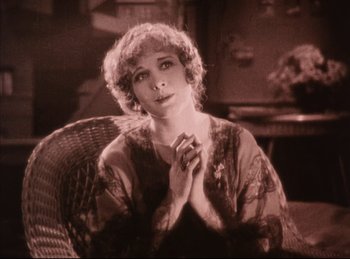 Movie still from “Peter Pan” (1924), directed by Herbert Brenon – An old photo of a woman sitting in a wicker chair; Medium shot, High angle
