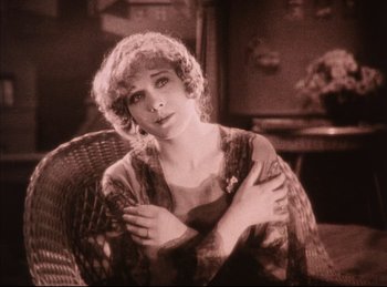 Movie still from “Peter Pan” (1924), directed by Herbert Brenon – An old photo of a woman sitting in a wicker chair; Close Up shot, High angle