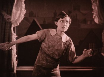 Movie still from “Peter Pan” (1924), directed by Herbert Brenon – A young woman is performing in a show; Medium shot, Low angle