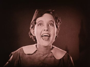 Movie still from “Peter Pan” (1924), directed by Herbert Brenon – An old photo of a woman smiling with her mouth wide open; Close Up shot, Low angle