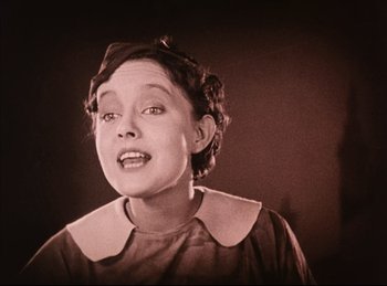 Movie still from “Peter Pan” (1924), directed by Herbert Brenon – An old photo of a young woman with short curly hair; Close Up shot, Low angle