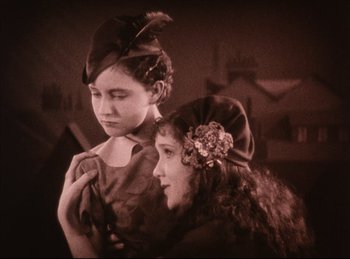 Movie still from “Peter Pan” (1924), directed by Herbert Brenon – Two young children dressed up in old fashion clothing; Medium shot, High angle