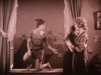 Movie still from “Peter Pan” (1924), directed by Herbert Brenon – An old photo of a woman and a boy on a stage; Wide shot, High angle