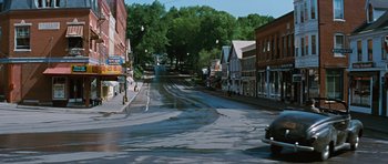 Movie still from “Peyton Place” (1957), directed by Mark Robson – A city street filled with lots of traffic; Extreme Wide shot, High angle