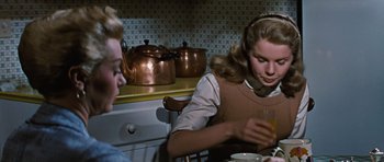Movie still from “Peyton Place” (1957), directed by Mark Robson – Two women sitting at a table in front of a stove; Medium shot, Over the shoulder angle