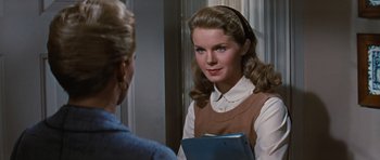 Movie still from “Peyton Place” (1957), directed by Mark Robson – A young woman is looking at a mirror; Close Up shot, Over the shoulder angle