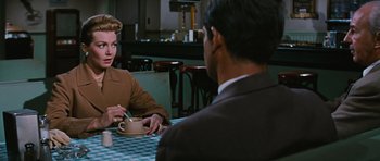 Movie still from “Peyton Place” (1957), directed by Mark Robson – A man and woman sitting at a table having a conversation; Medium shot, Over the shoulder angle