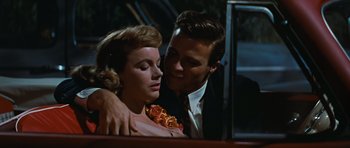 Movie still from “Peyton Place” (1957), directed by Mark Robson – A man and a woman are kissing in a car; Close Up shot, Low angle