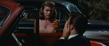 Movie still from “Peyton Place” (1957), directed by Mark Robson – A man and a woman sitting in the back of a car; Medium shot, Over the shoulder angle