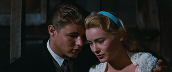 Movie still from “Peyton Place” (1957), directed by Mark Robson – A man and a woman looking at one another; Close Up shot, Low angle