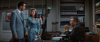 Movie still from “Peyton Place” (1957), directed by Mark Robson – A man and a woman are sitting at a table; Medium shot, Over the shoulder angle