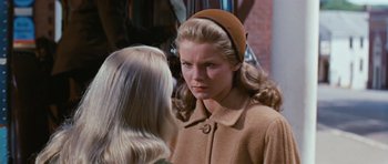 Movie still from “Peyton Place” (1957), directed by Mark Robson – A woman in a brown coat and a woman in a brown hat; Close Up shot, Over the shoulder angle