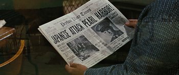 Movie still from “Peyton Place” (1957), directed by Mark Robson – A person holding up a newspaper in front of a window; Extreme Close Up shot, Over the shoulder angle