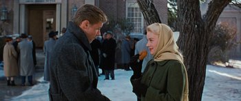 Movie still from “Peyton Place” (1957), directed by Mark Robson – A man and a woman standing next to each other in the snow; Medium shot, Over the shoulder angle