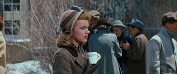 Movie still from “Peyton Place” (1957), directed by Mark Robson – A woman in a hat holding a coffee cup; Close Up shot, Over the shoulder angle