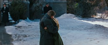 Movie still from “Peyton Place” (1957), directed by Mark Robson – A man and a woman hugging in the snow; Medium shot, Over the shoulder angle