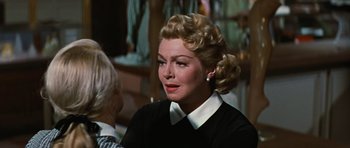 Movie still from “Peyton Place” (1957), directed by Mark Robson – A person wearing a black shirt; Close Up shot, Over the shoulder angle