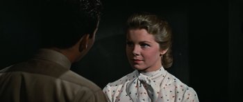 Movie still from “Peyton Place” (1957), directed by Mark Robson – A woman in a white shirt and a man in a tie; Close Up shot, Over the shoulder angle