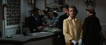 Movie still from “Peyton Place” (1957), directed by Mark Robson – A group of people standing around a counter; Medium shot, Low angle