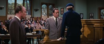 Movie still from “Peyton Place” (1957), directed by Mark Robson – A man and a woman in a court room; Medium shot, Over the shoulder angle