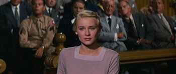 Movie still from “Peyton Place” (1957), directed by Mark Robson – A woman with blonde hair wearing a purple sweater; Medium shot, High angle