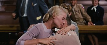 Movie still from “Peyton Place” (1957), directed by Mark Robson – A man and a woman embracing each other; Medium shot, Over the shoulder angle