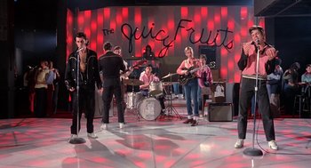 Movie still from “Phantom of the Paradise” (1974), directed by Brian De Palma – A group of young people performing on a stage; Wide shot, Low angle