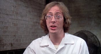 Movie still from “Phantom of the Paradise” (1974), directed by Brian De Palma – A man in a white lab coat and glasses; Close Up shot, Over the shoulder angle