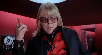 Movie still from “Phantom of the Paradise” (1974), directed by Brian De Palma – A woman with blonde hair wearing a black and red jacket; Close Up shot, Low angle